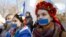 Women with their mouths taped over attend a pro-Ukraine rally in Simferopol, March 13, 2014. 