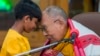 Pemimpin spiritual Tibet Dalai Lama menyentuh dahi seorang anak laki-laki sebelum berbicara kepada sekelompok siswa di kuil Tsuglakhang di Dharamshala, India, Selasa, 28 Februari 2023. (AP/Ashwini Bhatia)