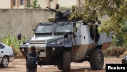 FILE - Presidential guard soldiers are seen on an armored vehicle at Laico hotel in Ouagadougou, Burkina Faso, Sept. 20, 2015. 