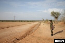 FILE - An Ethiopian military officer stands guard on the outskirts of Badme, a territorial dispute town between Eritrea and Ethiopia currently occupied by Ethiopia, June 8, 2018.