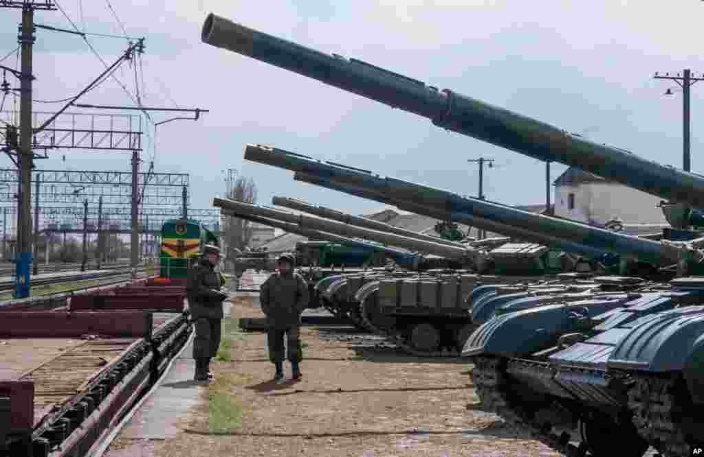Ukrainian armored vehicles are prepared for loading onto a train at a railway station near Simferopol, Crimea, March 29, 2014. 