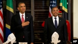 President Barack Obama and Tanzanian President Jakaya Kikwete stand for the national anthem during an official dinner at the State House in Dar es Salaam, Tanzania, July 1, 2013.