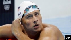 United States' Ryan Lochte checks his time in a men's 4x200-meter freestyle heat during the swimming competitions at the 2016 Summer Olympics, in Rio de Janeiro, Brazil, August 9, 2016.