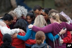 Parents gather in a circle to pray at a recreation center where students were reunited with their parents after a shooting at a suburban Denver middle school in Highlands Ranch, Colorado, May 7, 2019.