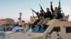 Members of the Syrian Democratic Forces (SDF) deploy outside al-Sina’a prison in Syria's northeastern city of Hasakah, Jan. 26, 2022.