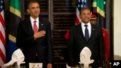 President Barack Obama and Tanzanian President Jakaya Kikwete stand for the national anthem during an official dinner at the State House in Dar es Salaam, Tanzania, July 1, 2013.