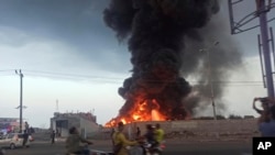 A large fire and plume of smoke is visible in the port city of Hodeida, Yemen, on Sept. 29, 2024, after Israeli strikes on the Houthi-controlled city. 