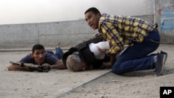 Lực lượng an ninh Ai Cập ôm thi thể bất động của tướng cảnh sát Nabil Farag, bị bắn chết trong cuộc hành quân ở Kerdasah, một cứ địa của phe Hồi giáo, ngày 19/8/2013.