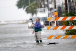 Charles Marsala, who lives in the Orleans Marina in the West End section of New Orleans, films a rising storm surge from Lake Pontchartrain, in advance of Tropical Storm Cristobal, June 7, 2020.