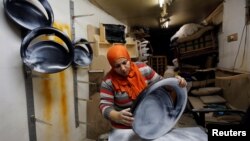 FILE - Carpenter-designer Asmaa Megahed, 30, is pictured in her workshop in Cairo.