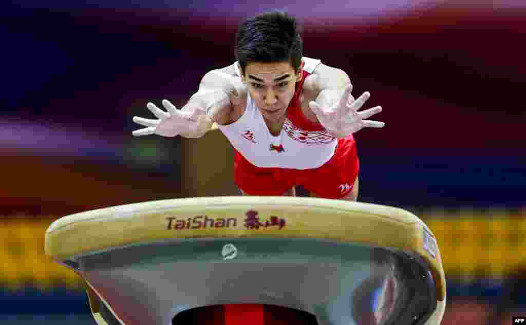 Dzianis Sanuvonh of Belarus competes in the vault during the first day of the 48th FIG Artistic Gymnastics Championships at the Aspire Dome in the Qatari capital Doha.