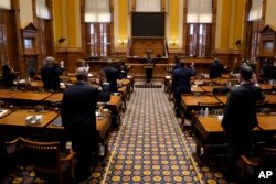 Members of Georgia's Electoral College are sworn in before casting their votes at the state Capitol, Monday, Dec. 14, 2020, in Atlanta. (AP Photo/John Bazemore, Pool)