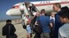 FILE - Passengers board an Air Koryo plane bound for Beijing, at the Pyongyang International Airport in Pyongyang, North Korea, June 27, 2015.