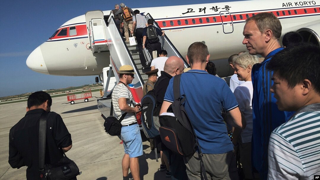 FILE - Passengers board an Air Koryo plane bound for Beijing, at the Pyongyang International Airport in Pyongyang, North Korea, June 27, 2015.
