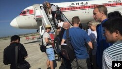 FILE - Passengers board an Air Koryo plane bound for Beijing, at the Pyongyang International Airport in Pyongyang, North Korea, June 27, 2015.