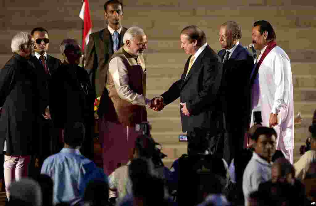 India&rsquo;s new prime minister Narendra Modi, center left, shakes hands with his Pakistani counterpart Nawaz Sharif, as Sri Lankan President Mahinda Rajapaksa, right, and Mauritius Prime Minister Navinchandra Ramgoolam, second right, watch during Modi&rsquo;s inauguration in New Delhi. Modi took the oath of office as India&#39;s new prime minister at the sprawling presidential palace, a moment made more historic by the presence of the leader of archrival Pakistan.