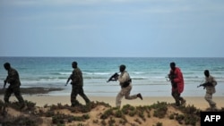 Somali security forces patrol along the coast of Qaw, in Puntland, northeastern Somalia, Dec. 18, 2016.