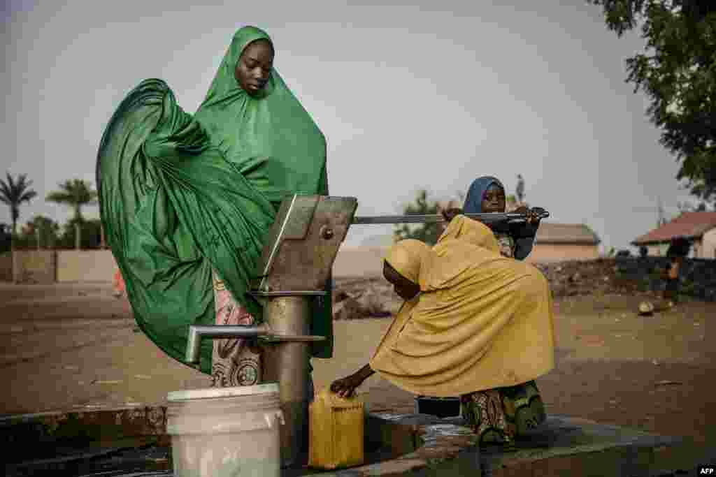 People pump water from a well at Malkohi refugee camp in Jimeta, Adamawa State, Nigeria, February 19, 2019.