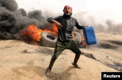 FILE - A Palestinian demonstrator is pictured during clashes with Israeli troops at a protest on the Israel-Gaza border where Palestinians are demanding the right to return to their homeland, April 20, 2018.