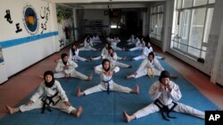 FILE - Female Afghan Taekwondo team members practice during a training session in Kabul, Afghanistan, March 1, 2021.