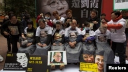 FILE - Pro-democracy activists shave their heads during a protest to call for the release of Liu Xia, wife of jailed Nobel Peace Prize Laureate Liu Xiaobo, in Hong Kong, Feb. 14, 2014.