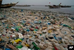 Trash and plastics litter the sand of Yarakh Beach in Dakar, Senegal, Nov. 8, 2022.
