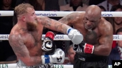 Jake Paul, left, fights Mike Tyson during their heavyweight boxing match on Nov. 15, 2024, in Arlington, Texas.