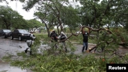Members of the National Guard remove tree branches from a street after Hurricane Grace made landfall on the Yucatan Peninsula, in Merida, Mexico, Aug. 19, 2021.