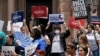 Demonstrators protest proposed voting bills on the steps of the Texas Capitol, July 13, 2021, in Austin, Texas.