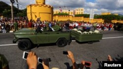 The ashes of former Cuban President Fidel Castro are driven past the Moncada Army Barracks, where Castro led a failed assault in 1953 that sparked the movement that eventually toppled the U.S.-backed government of dictator Fulgencio Batista, in Santiago 