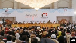 Yemeni participants attend the closing of the so-called national dialogue talks in Sanaa, Yemen, Saturday, Jan. 25, 2014. The long-running negotiations has brought delegates from across the country to draw up a blueprint for a new constitution under a tra