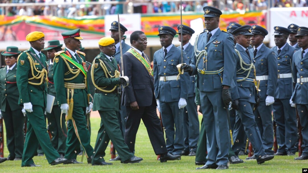 Zimbabwe's President Emmerson Mnangagwa, center, inspects the guard of honour during the celebrations for the country's 38th anniversary of Independence at the National Sports Stadium in Harare, Apr. 18, 2018. 