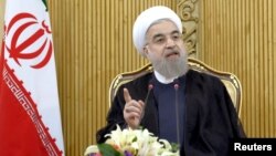 FILE - Iranian President Hassan Rouhani speaks in Tehran after returning from the annual United Nations General Assembly, Sept. 29, 2015. 