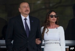 FILE - Azerbaijan's President Ilham Aliyev and his wife, Mehriban Aliyeva, watch the last minutes of the Formula One Grand Prix of Europe at the Baku Circuit in Baku, Azerbaijan, June 19, 2016.