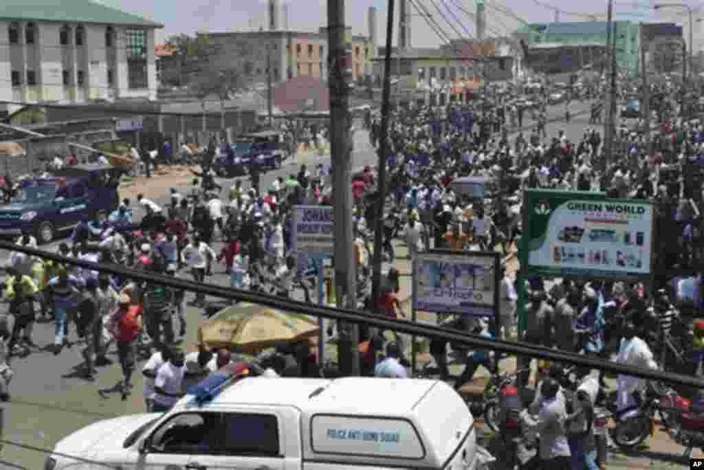 People gather at the site of a bomb explosion in Kaduna, Nigeria, Thursday, April. 26, 2012.