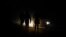 FILE: Locals are illuminated by car lights as they walk on the dark streets during frequent power outages from South African utility Eskom, caused by its aging coal-fired plants, at Lawley Township, South Africa. Taken July 13, 2022. 