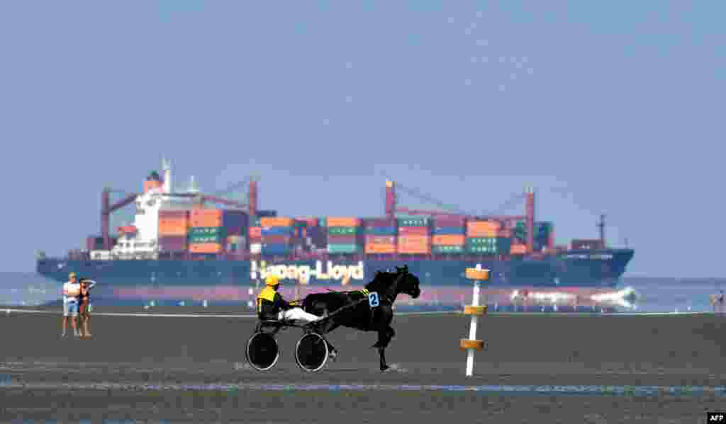 A horse rider competes during the traditional &quot;Duhner Wattrennen&quot; mudflat race in Cuxhaven, northern Germany, Aug. 25, 2019.