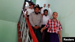 Muslim men accused of murdering a monk, believed to be the first killing in the March unrest, walk out of court in Meikhtila, Burma, April 24, 2013.