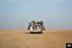 FILE - Nigeriens and third-country migrants head towards Libya from Agadez, Niger, June 4, 2018.