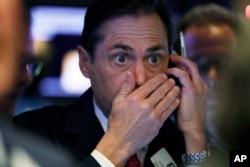 FILE - Trader Dudley Devine works on the floor of the New York Stock Exchange, Dec. 6, 2018.