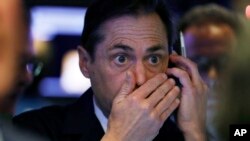 Trader Dudley Devine works on the floor of the New York Stock Exchange, Dec. 6, 2018. 