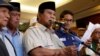 Indonesia's presidential candidate Prabowo Subianto delivers a speech to declare election victory as his running mate Sandiaga Uno stands next to him in Jakarta, Indonesia, April 18, 2019. 