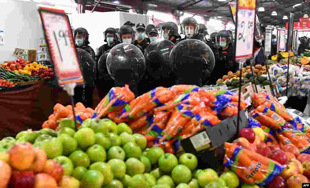 Riot police clear Melbourne&#39;s Queen Victoria Market of anti-lockdown protesters during a rally on amid the COVID-19 pandemic.