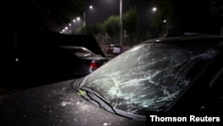 Car with damaged windshield is seen following an explosion at a Yima gas factory nearby, in Sanmenxia.