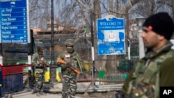 Indian paramilitary soldiers stand guard near a temporary check point during a strike in Srinagar, Indian controlled Kashmir, Feb. 3, 2019.