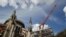 A picture taken on August 19, 2019 shows a crane at the cathedral of Notre-Dame of Paris worksite. 