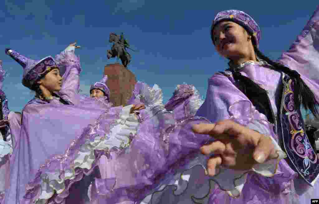 Mulheres do Kirguistão envergando trajes regionais festejam o Nowruz, o Ano Novo.