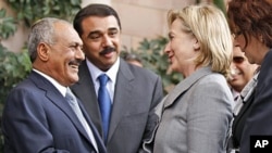 Yemeni President Ali Abdullah Saleh, left, shakes hands with US Secretary of State Hillary Clinton following her arrival for a visit to Yemen January 11, 2011.