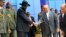 South Sudan's President Salva Kiir (3rd L) shakes hands with Sudan's President Omar al-Bashir as he arrives for talks at Khartoum Airport, Sept. 3, 2013.