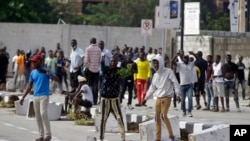 FILE - Young people protest at the Lekki Toll Gate in Lagos, Nigeria, Oct. 21, 2020. The Lekki gate was the site where demonstrators were fired upon earlier in the week in an escalation that sparked global outrage.